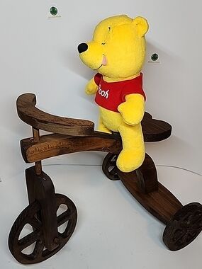 Winnie the Pooh Plush Toy in Yellow with Red Shirt On Wood Tri-cycle